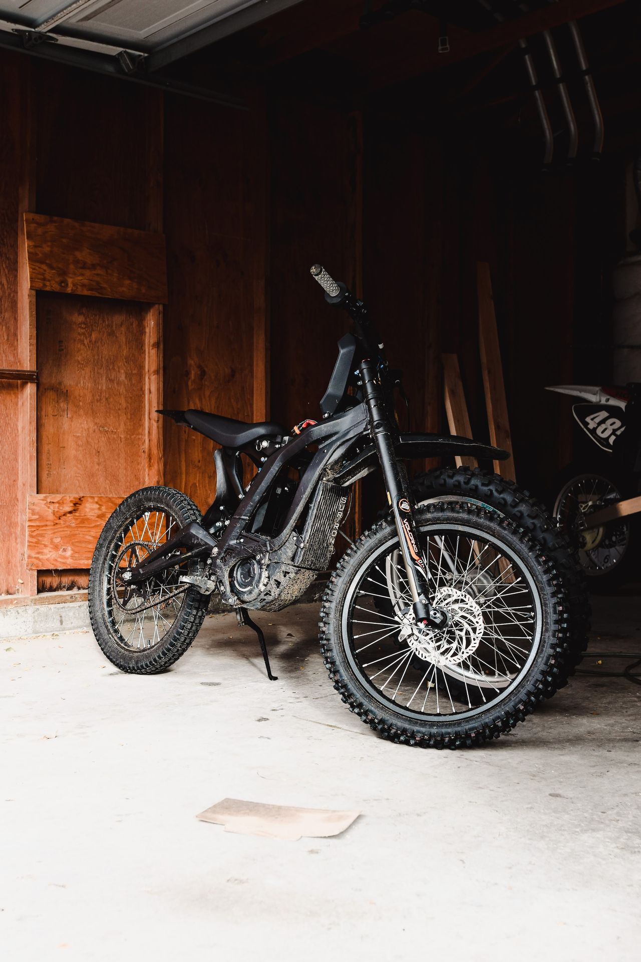 a dirt bike parked inside of a garage